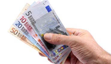 hand-holding-euros-currency.jpg